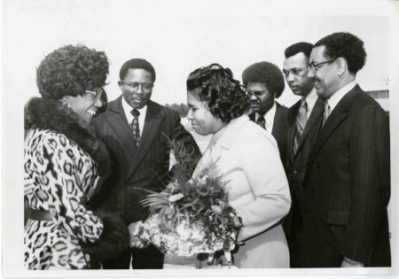 Photograph of Shirley Chisholm greeting a group of people