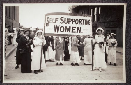 Young women with sign 'Self Supporting Women.'